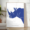A rhinoceros standing in a natural habitat with blue and black tones - in a bright minimalist room with a plant and an armchair