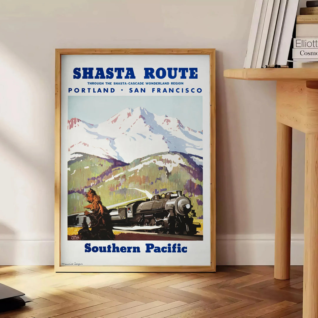 Travel poster featuring San Francisco and Portland with gray and green tones - beside a round wooden side table with books
