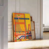 Illustration of San Francisco skyline with warm brown and orange tones - leaning on a herringbone floor against a white panelled wall
