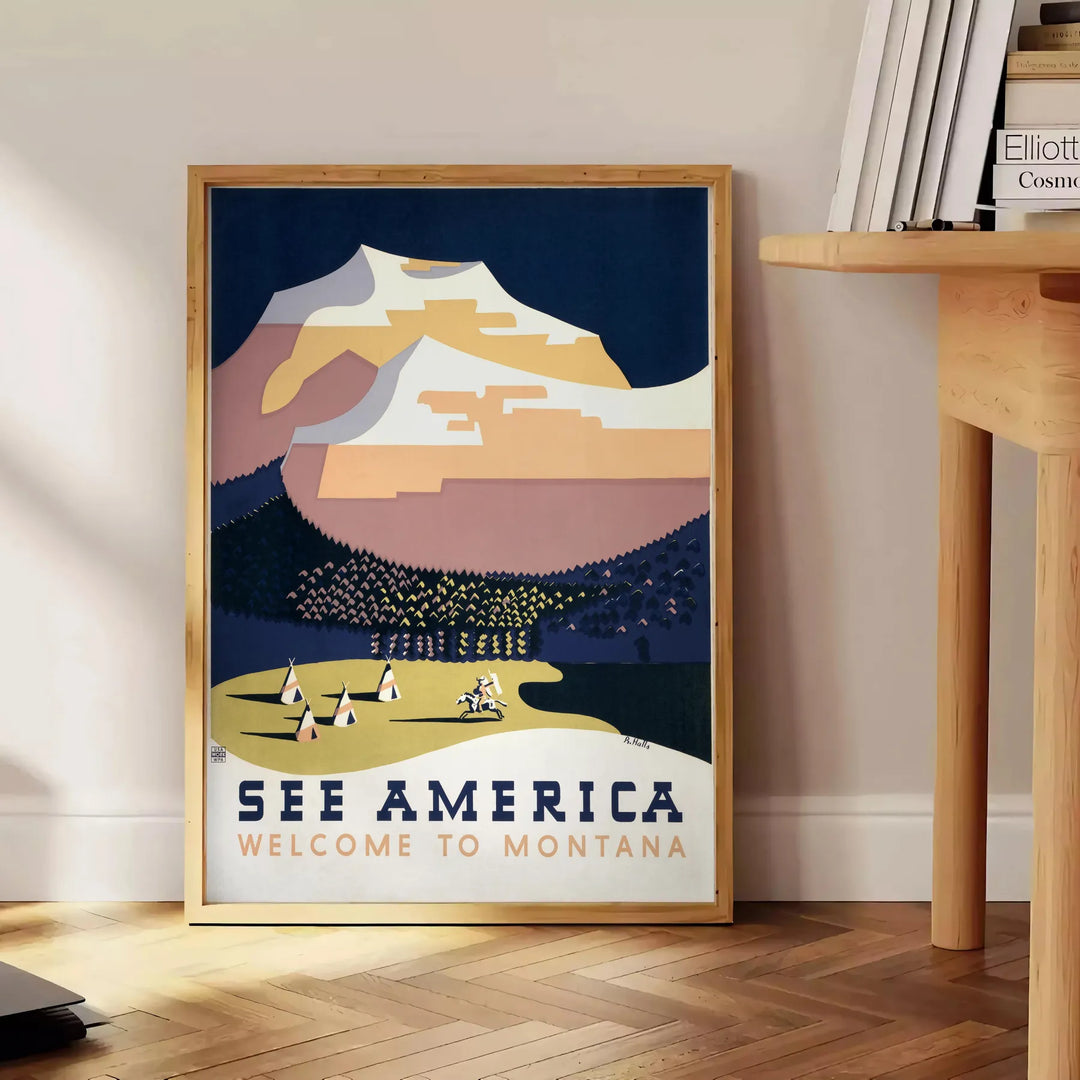 Montana landscape with mountains and trees in muted gray and black tones - beside a round wooden side table with books