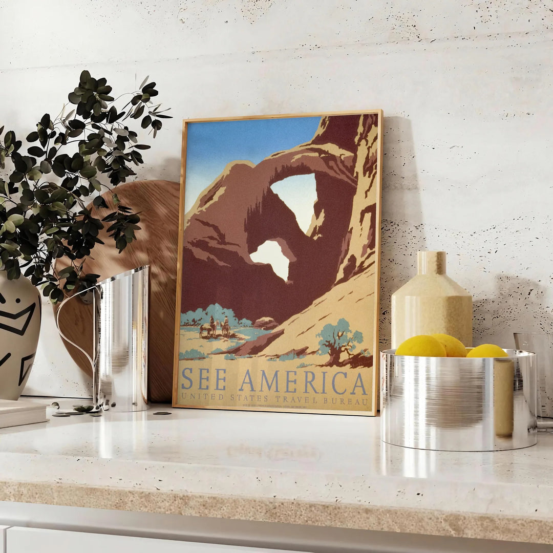 Travel poster featuring a serene landscape of America in gray and green tones - styled on a counter with eucalyptus and a bowl of lemons