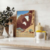 Travel poster featuring a serene landscape of America in gray and green tones - styled on a counter with eucalyptus and a bowl of lemons