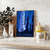 A vintage-style travel poster featuring iconic American landscapes in blue and black tones - styled on a counter with eucalyptus and a bowl of lemons