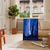 A vintage-style travel poster featuring iconic American landscapes in blue and black tones - in a Parisian living room with a sofa and a fig plant