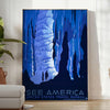A vintage-style travel poster featuring iconic American landscapes in blue and black tones - in a bright minimalist room with a plant and an armchair
