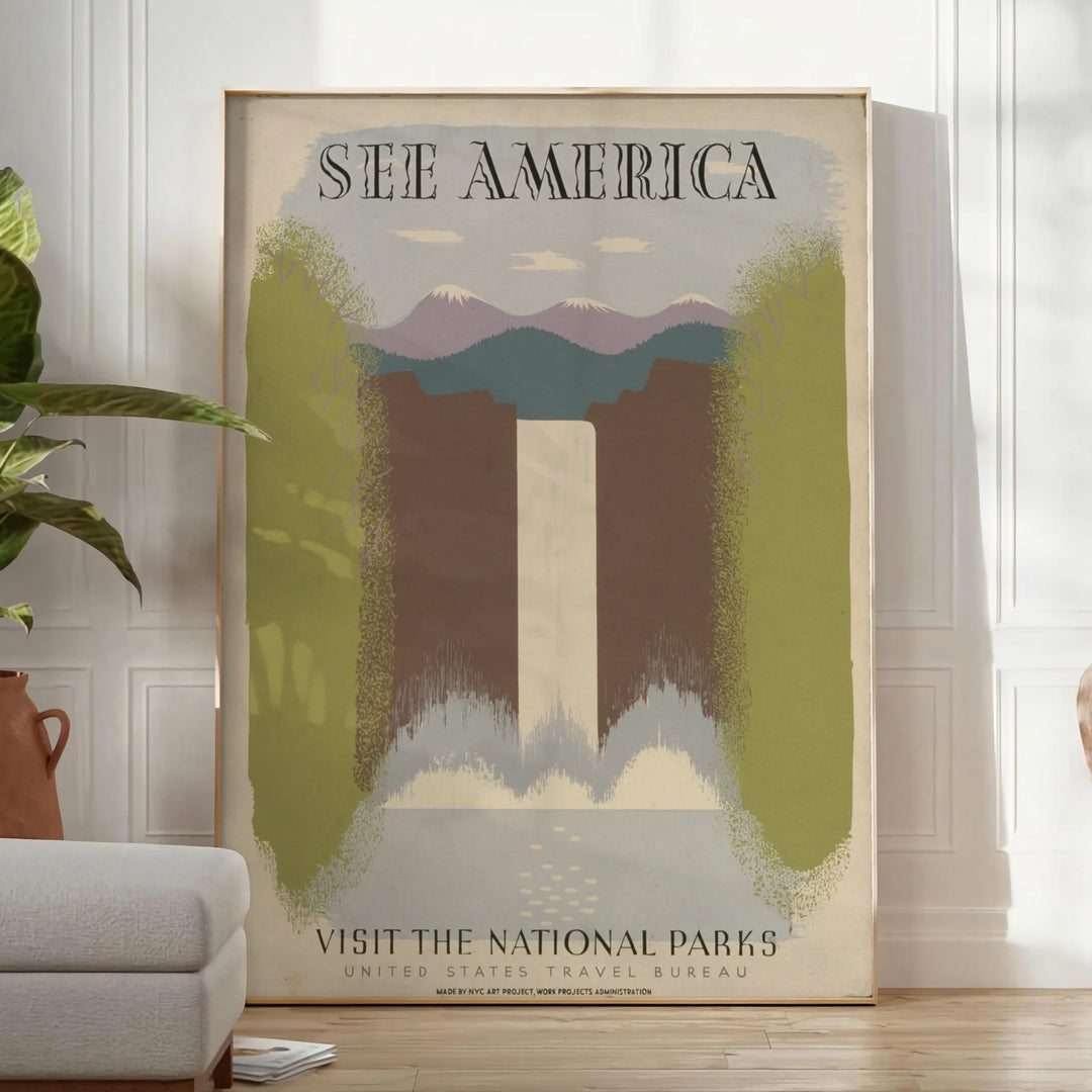 A vintage travel poster featuring the text 'See America' with green and gray landscapes. - in a bright minimalist room with a plant and an armchair