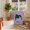 A serene yoga pose silhouette against calming green and blue tones - in a Parisian living room with a sofa and a fig plant