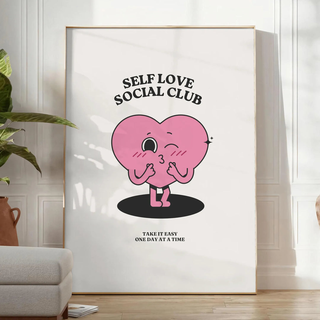 Minimalist poster featuring the phrase 'Self Love Social Club' in bold typography against a gray background - in a bright minimalist room with a plant and an armchair