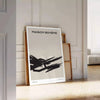 Abstract shapes in black and orange with a bohemian style - leaning on a herringbone floor against a white panelled wall