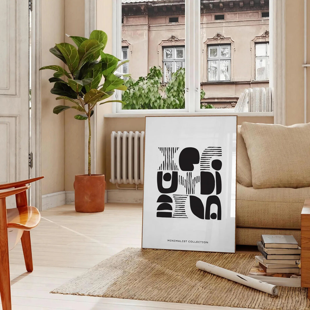 Abstract shapes in a bohemian style with gray and black tones - in a Parisian living room with a sofa and a fig plant