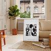 Abstract shapes in a bohemian style with gray and black tones - in a Parisian living room with a sofa and a fig plant