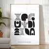 Abstract shapes in a bohemian style with gray and black tones - in a bright minimalist room with a plant and an armchair