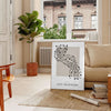 Intricate boho shapes in earthy tones on a textured background - in a Parisian living room with a sofa and a fig plant