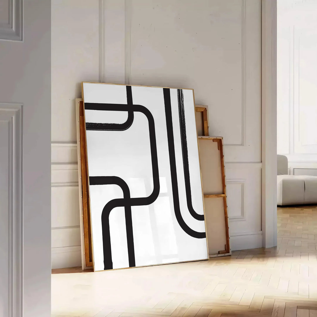 Abstract shapes in black and blue with a boho style - leaning on a herringbone floor against a white panelled wall
