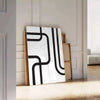 Abstract shapes in black and blue with a boho style - leaning on a herringbone floor against a white panelled wall