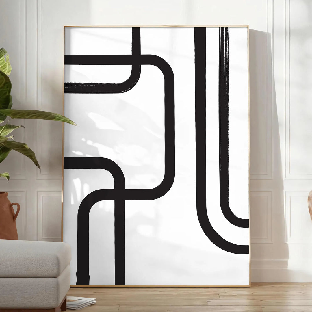 Abstract shapes in black and blue with a boho style - in a bright minimalist room with a plant and an armchair