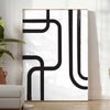 Abstract shapes in black and blue with a boho style - in a bright minimalist room with a plant and an armchair
