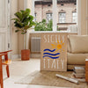 Vintage poster featuring Sicily with blue and orange tones - in a Parisian living room with a sofa and a fig plant