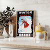 A minimalist ski travel poster featuring a snowy mountain landscape in gray and black tones - styled on a counter with eucalyptus and a bowl of lemons