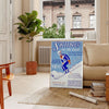 A ski scene with snowy slopes and blue skies - in a Parisian living room with a sofa and a fig plant