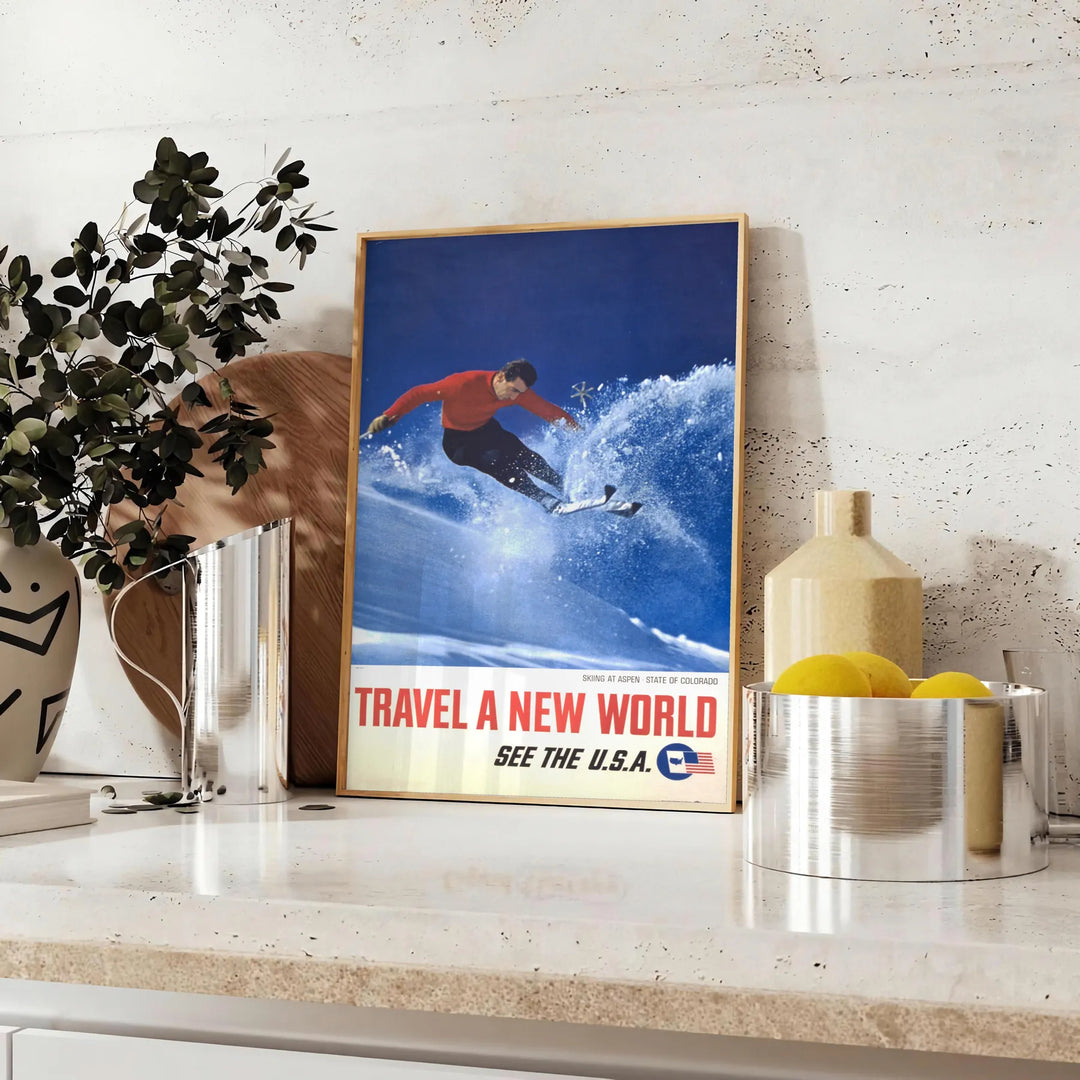 A skiing scene with dynamic slopes in orange and blue hues - styled on a counter with eucalyptus and a bowl of lemons