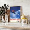 A skiing scene with dynamic slopes in orange and blue hues - styled on a counter with eucalyptus and a bowl of lemons