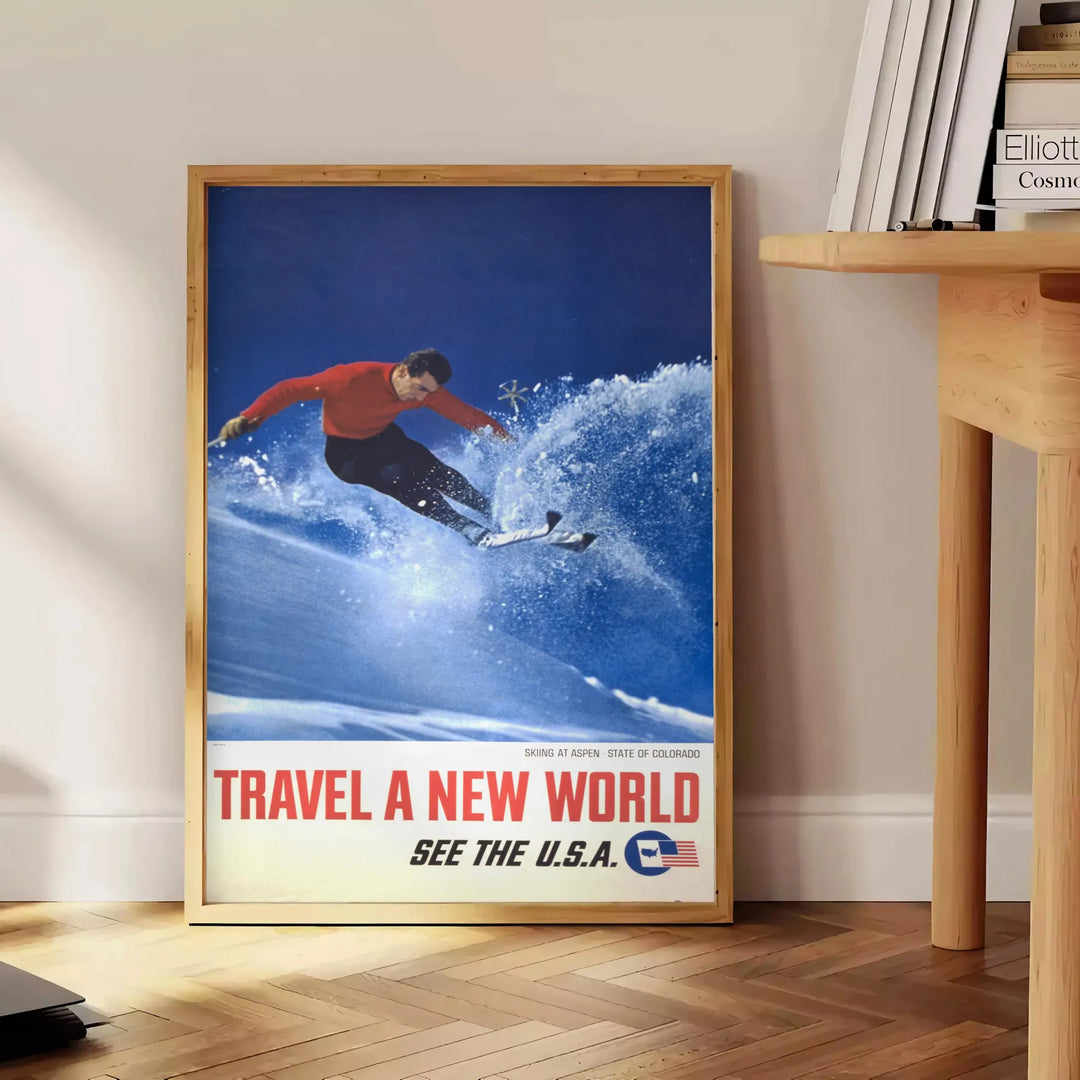 A skiing scene with dynamic slopes in orange and blue hues - beside a round wooden side table with books