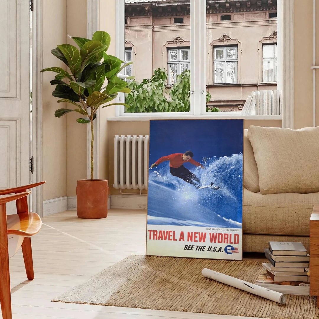 A skiing scene with dynamic slopes in orange and blue hues - in a Parisian living room with a sofa and a fig plant
