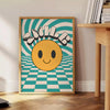 Design abstrato com um rosto sorridente em tons de laranja e preto - ao lado de uma mesa de apoio redonda em madeira com livros