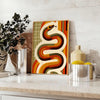 Midcentury-style illustration of a snake in orange and red tones - styled on a counter with eucalyptus and a bowl of lemons