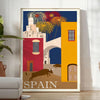 Vintage travel poster featuring Spain with blue and orange tones - in a bright minimalist room with a plant and an armchair