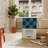 Abstract square shapes in black and brown tones - in a Parisian living room with a sofa and a fig plant