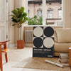 Abstract composition of squares and circles in black and brown tones - in a Parisian living room with a sofa and a fig plant