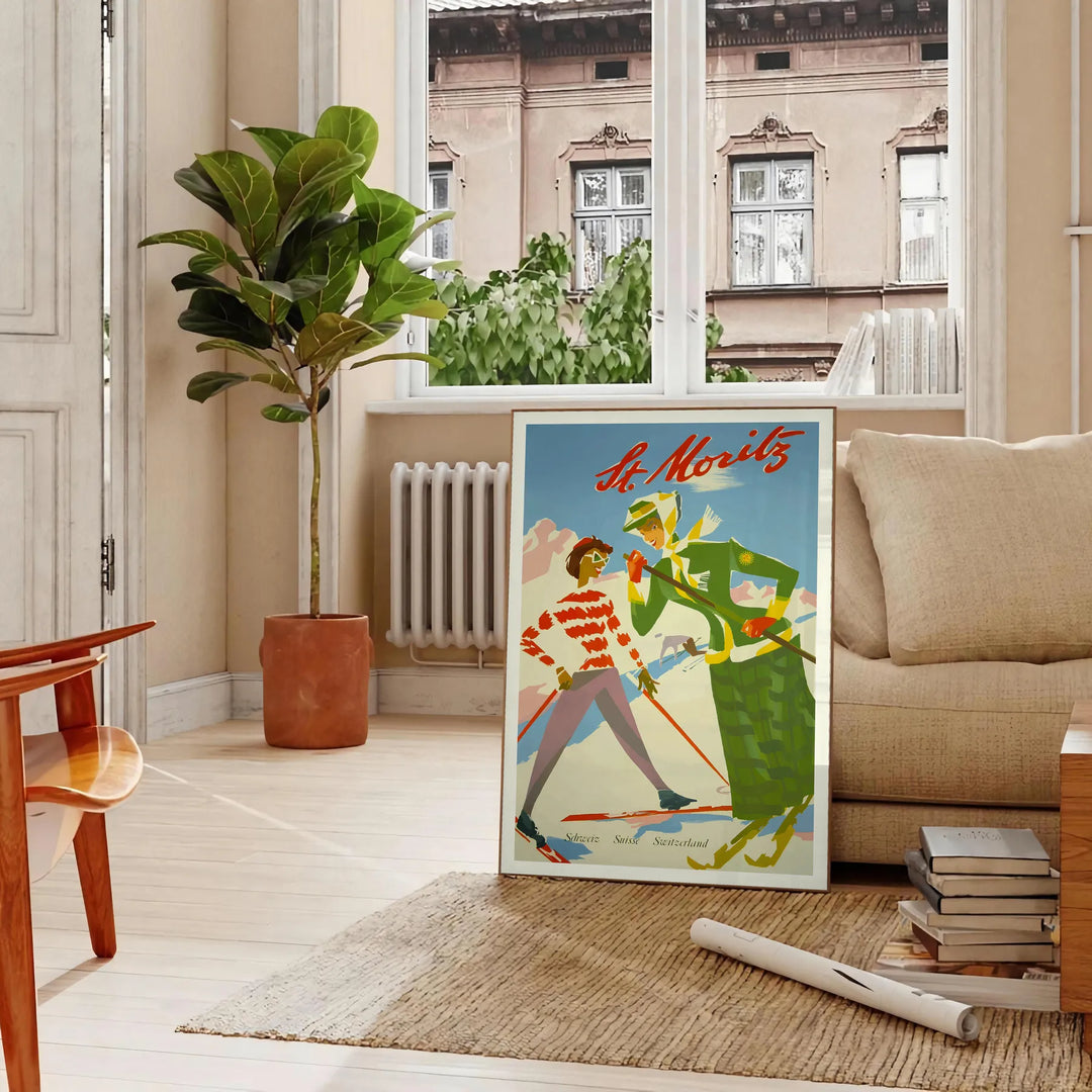 Vintage travel poster of St. Moritz featuring lush green mountains and serene blue skies - in a Parisian living room with a sofa and a fig plant