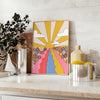 A retro-style poster featuring a large sunflower in yellow and brown tones - styled on a counter with eucalyptus and a bowl of lemons