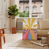 A retro-style poster featuring a large sunflower in yellow and brown tones - in a Parisian living room with a sofa and a fig plant