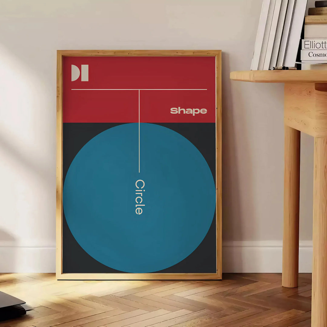 Abstract geometric shapes in black and green tones - beside a round wooden side table with books
