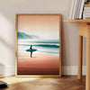 Dynamic waves in orange and green, capturing surf energy - beside a round wooden side table with books