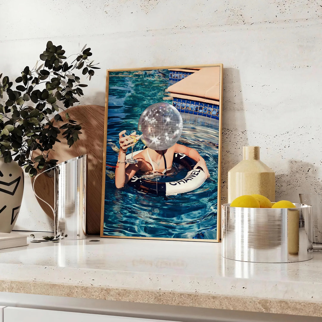 A stylized swimming pool scene with earthy browns and greens - styled on a counter with eucalyptus and a bowl of lemons