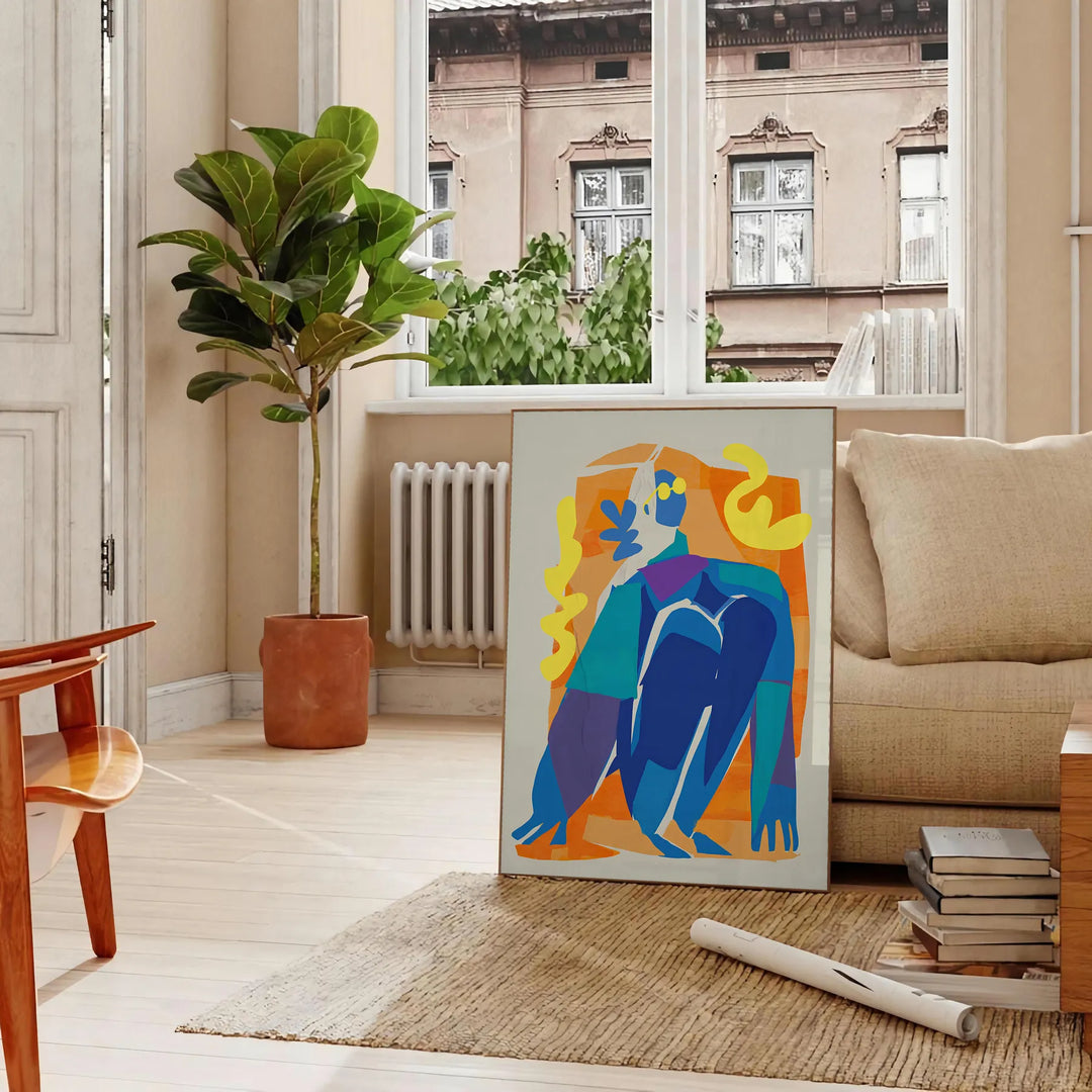 Maximalist poster featuring bold purple and orange hues with abstract shapes - in a Parisian living room with a sofa and a fig plant