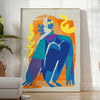 Maximalist poster featuring bold purple and orange hues with abstract shapes - in a bright minimalist room with a plant and an armchair