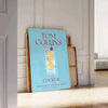 Illustration of a Tom Collins cocktail in a glass with lemon and cherry, yellow and blue colors - leaning on a herringbone floor against a white panelled wall