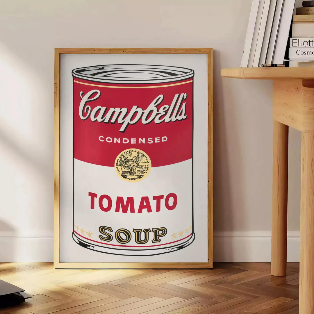 A colorful depiction of a tomato soup can with a vintage pub aesthetic - beside a round wooden side table with books