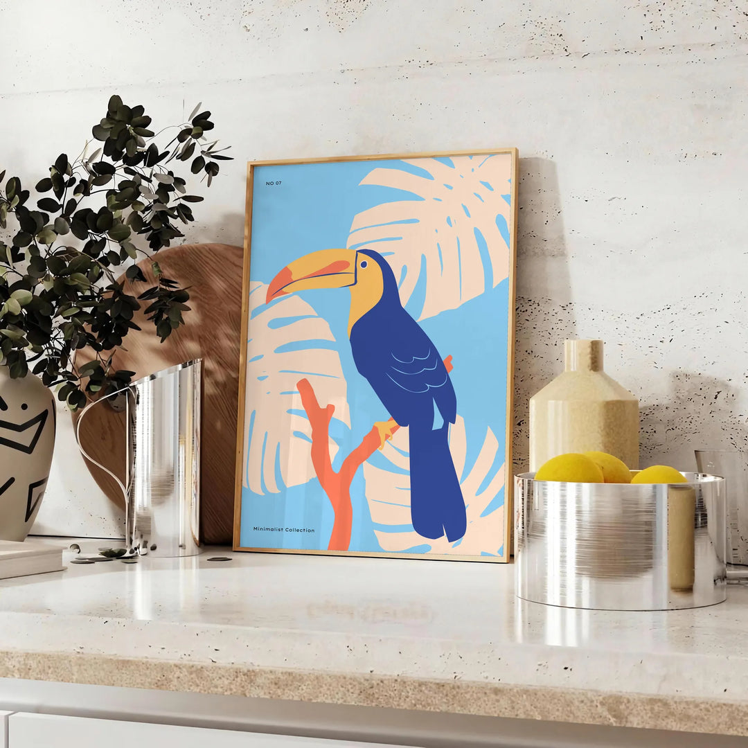 A colorful toucan perched on a branch with bright orange and blue feathers - styled on a counter with eucalyptus and a bowl of lemons