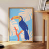 A colorful toucan perched on a branch with bright orange and blue feathers - beside a round wooden side table with books