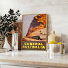 Illustration of a train traveling through lush Australian landscapes in green and blue tones - styled on a counter with eucalyptus and a bowl of lemons
