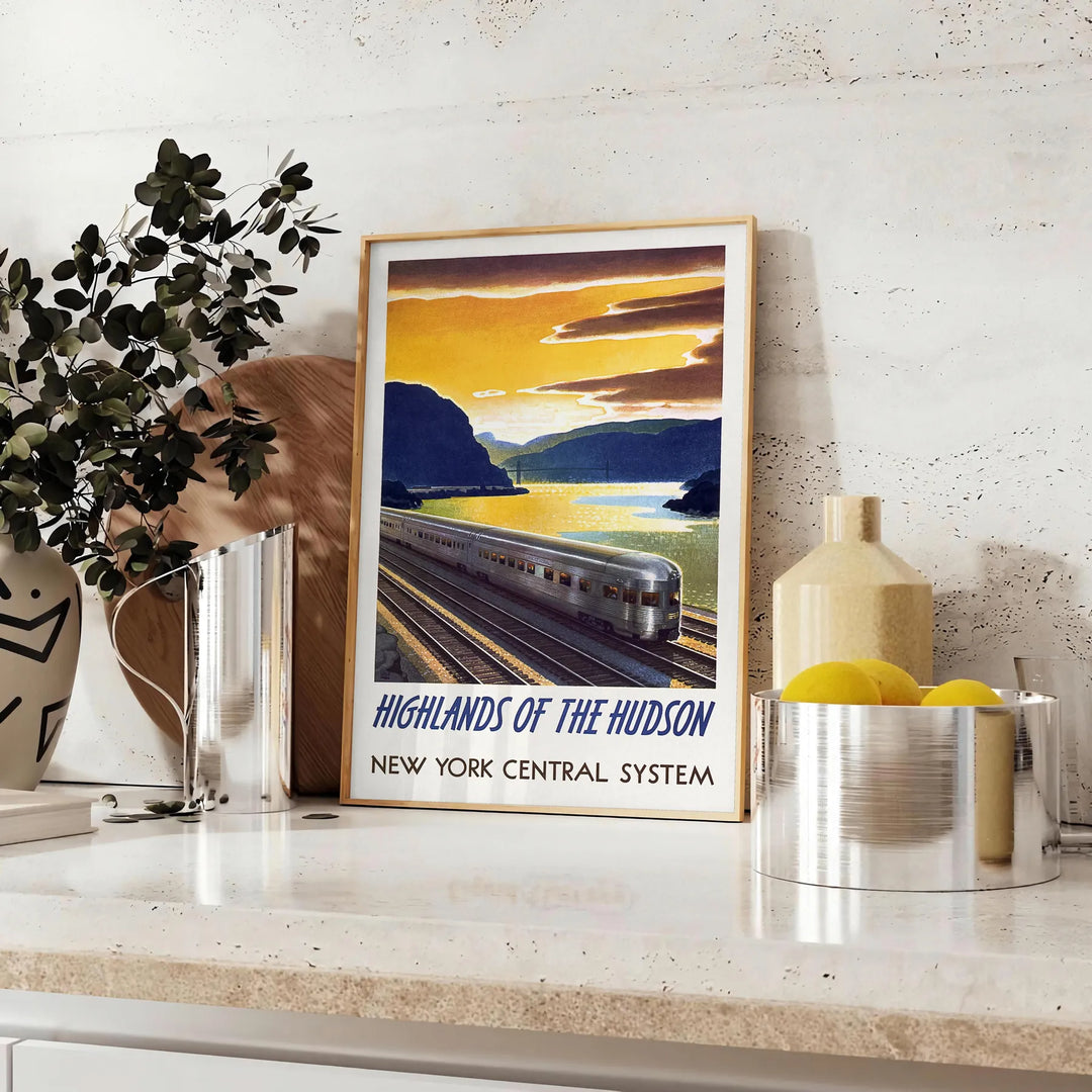A vintage-style train travel poster featuring a gray and blue color palette - styled on a counter with eucalyptus and a bowl of lemons