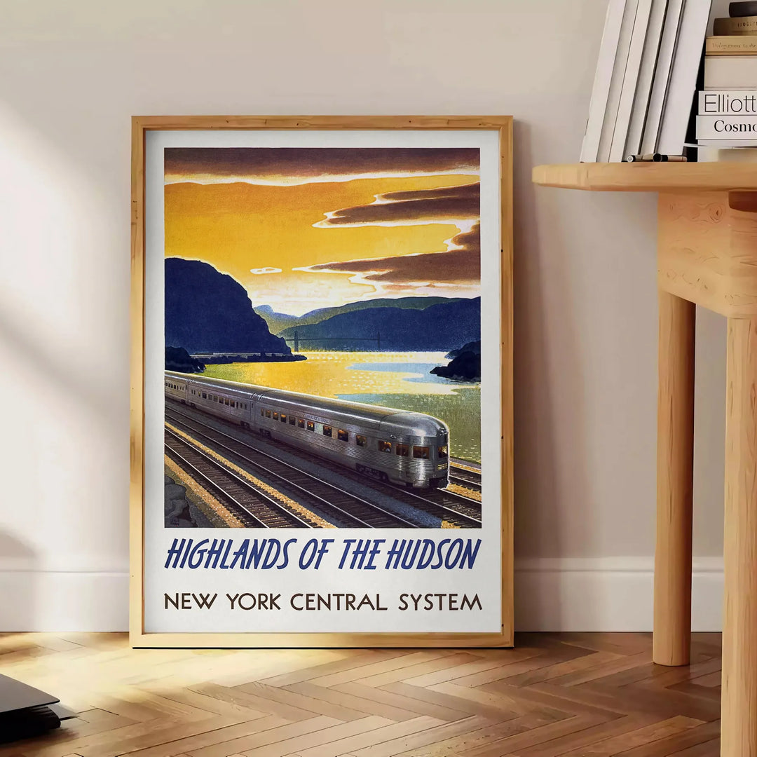 A vintage-style train travel poster featuring a gray and blue color palette - beside a round wooden side table with books