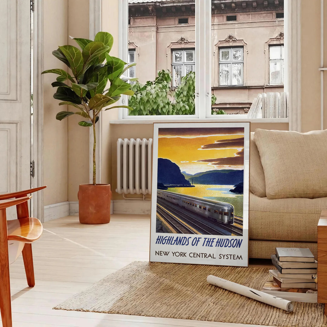 A vintage-style train travel poster featuring a gray and blue color palette - in a Parisian living room with a sofa and a fig plant