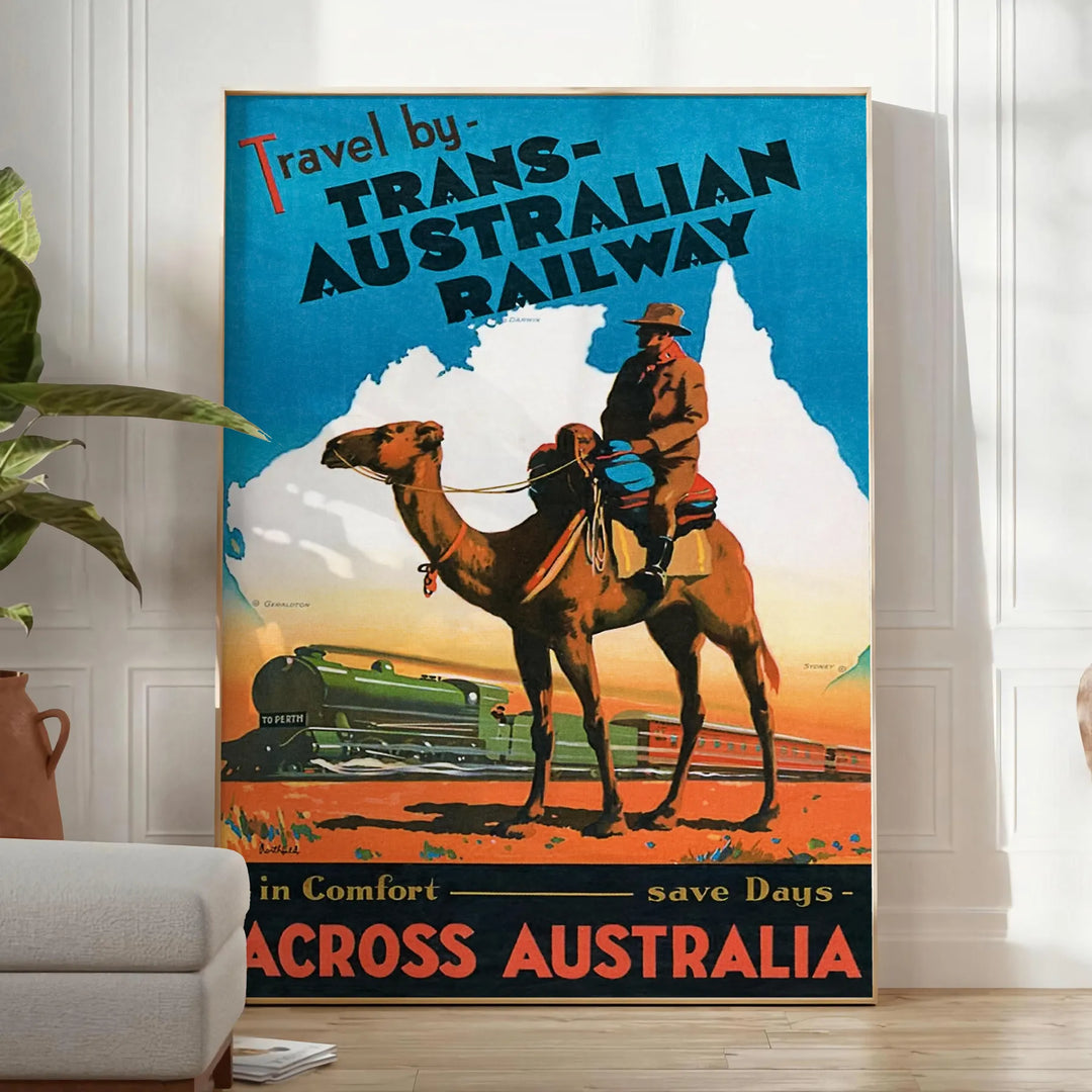 A vintage travel poster featuring a stylized landscape of Australia in black and blue tones - in a bright minimalist room with a plant and an armchair